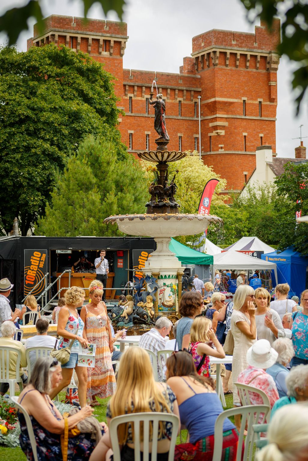 Image of Vivary Park from the fountain area, showing people enjoying music and food.