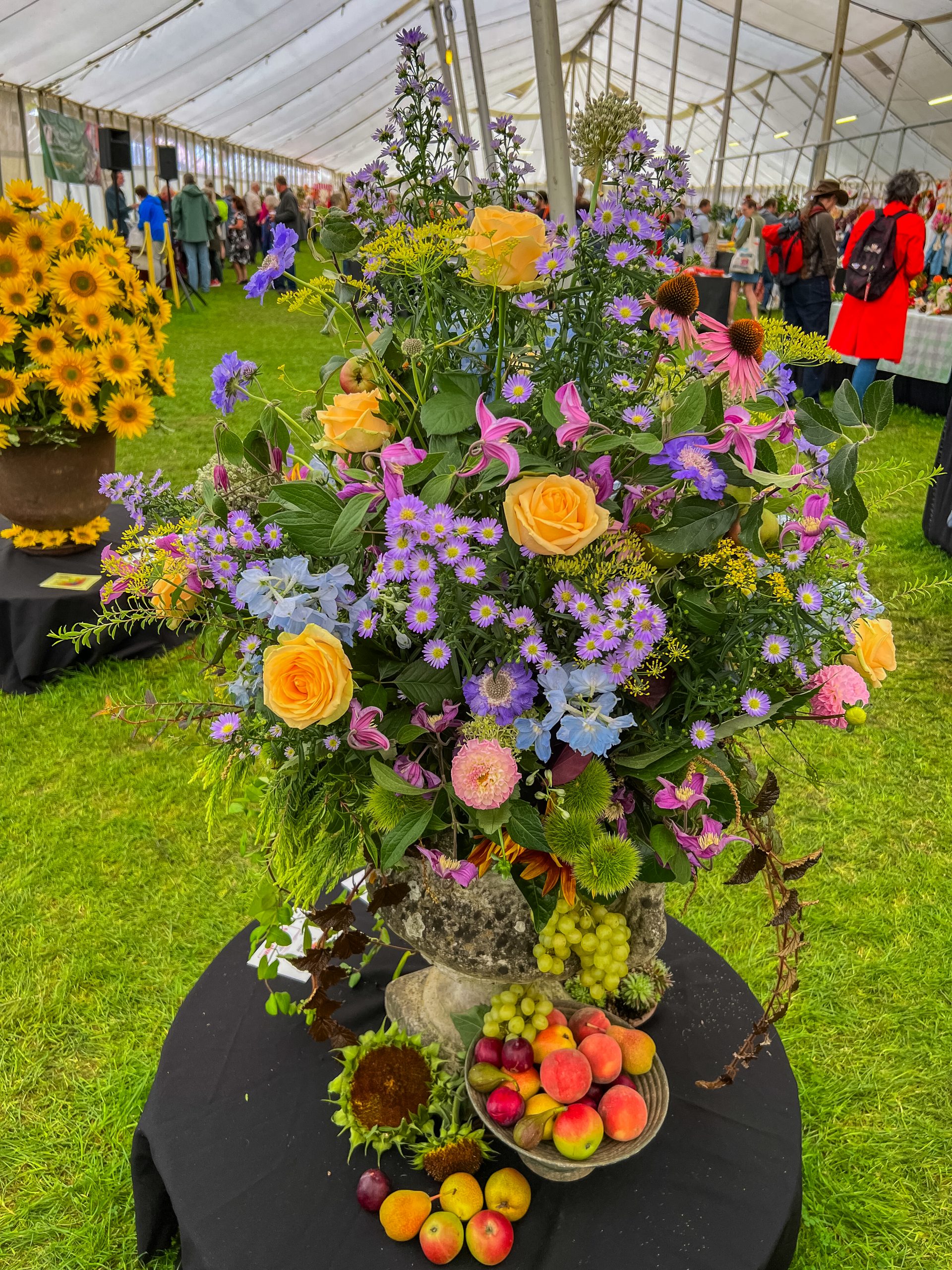 Floral Art display in the competition marquee - beautiful display of pink, yellow, blue and purple flowers and foliage